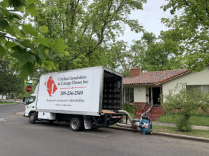 Coldani Insulation truck with equipment pipe leading into home